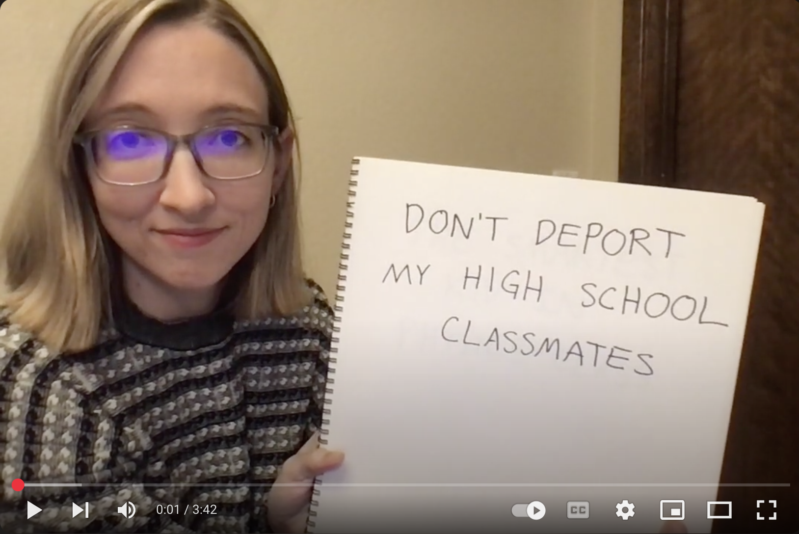 Video thumbnail with me holding a sign that says "Don't deport my high school classmates"